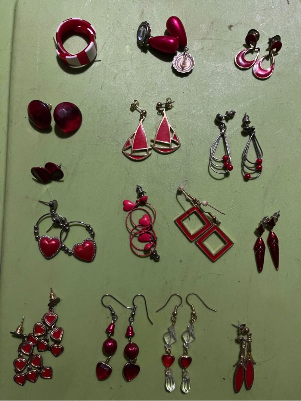15 pairs of red themed earrings,at least 3 are Avon all different styles,